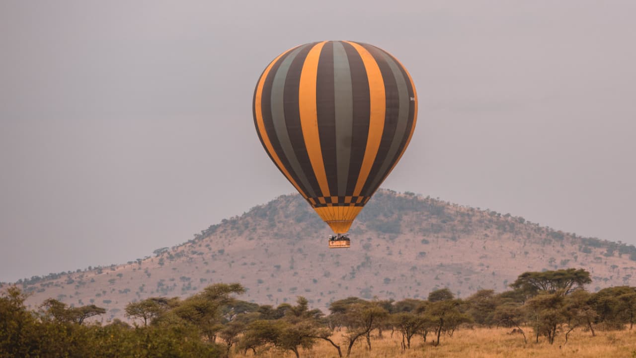 Tourists enjoying a pleasant balloon safari over the Serengeti National Park