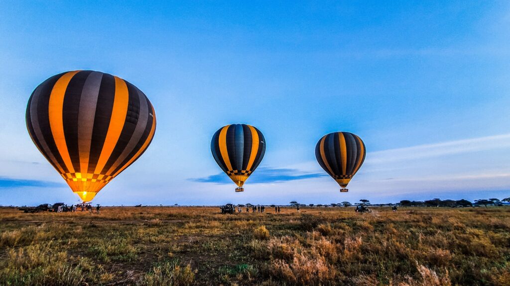Three hot air balloons taking off